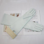 Gants cuir femme longs, coloris menthe, posés à plat
